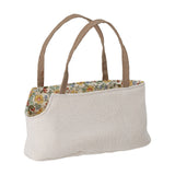 Hilena soft toy carry bag with woven handles and floral-print lining, shown on a plain white background.