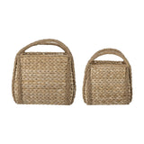 Selma Baskets Set of 2 in beige bankuan grass, two rectangular woven storage baskets with braided corner trim and arched loop handles, on a plain white background.