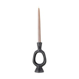 Bijan black resin candle holder with a sculptural open oval loop, flared neck, and conical foot, holding a single taper candle against a plain white background.