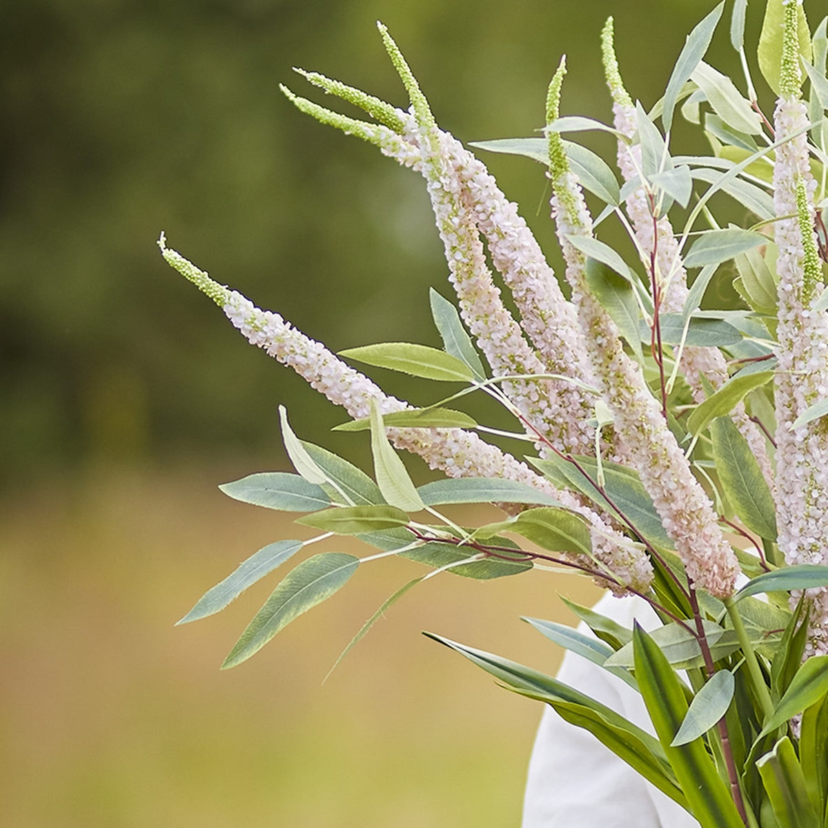 Foxtail Artificial Stem 73cm in pink, showing tapering flower spikes with slender green leaves, arranged in a bouquet against a blurred outdoor background.