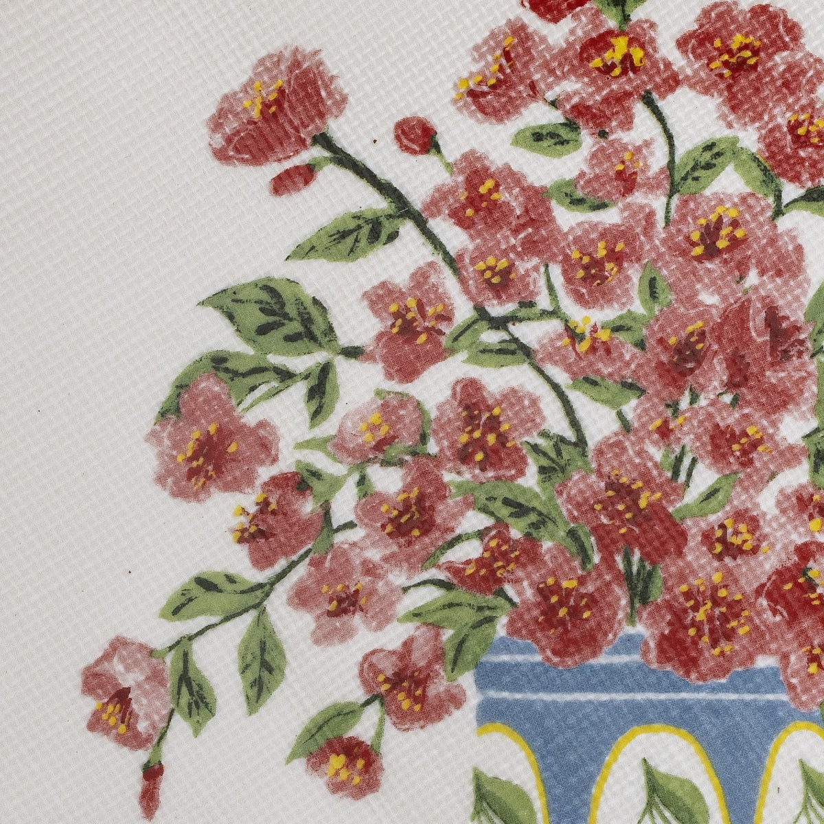 Close-up of the Dorothy Floral Stoneware Bowl 28cm in white, showing a painted red floral branch design with green leaves above a blue and yellow patterned base.