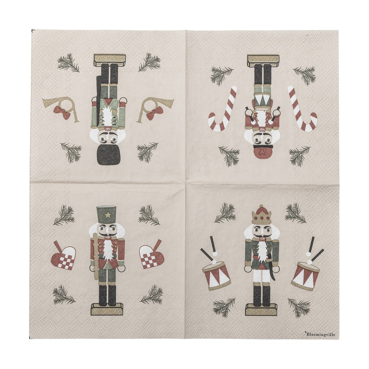 Beige paper Christmas napkin from the Jolly pack of 20, printed with four nutcracker designs per quarter including drums, candy canes, horns, and woven hearts.