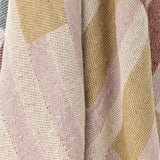 Close-up of the Lane Striped Throw in multicoloured woven cotton blend, showing draped fabric with pink, mustard, cream and rust block stripes.