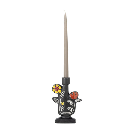 Vivielle Floral Stoneware Candle Holder in black with hand-painted yellow and red flowers and leaf outlines, holding a tall taper candle on a plain white background.