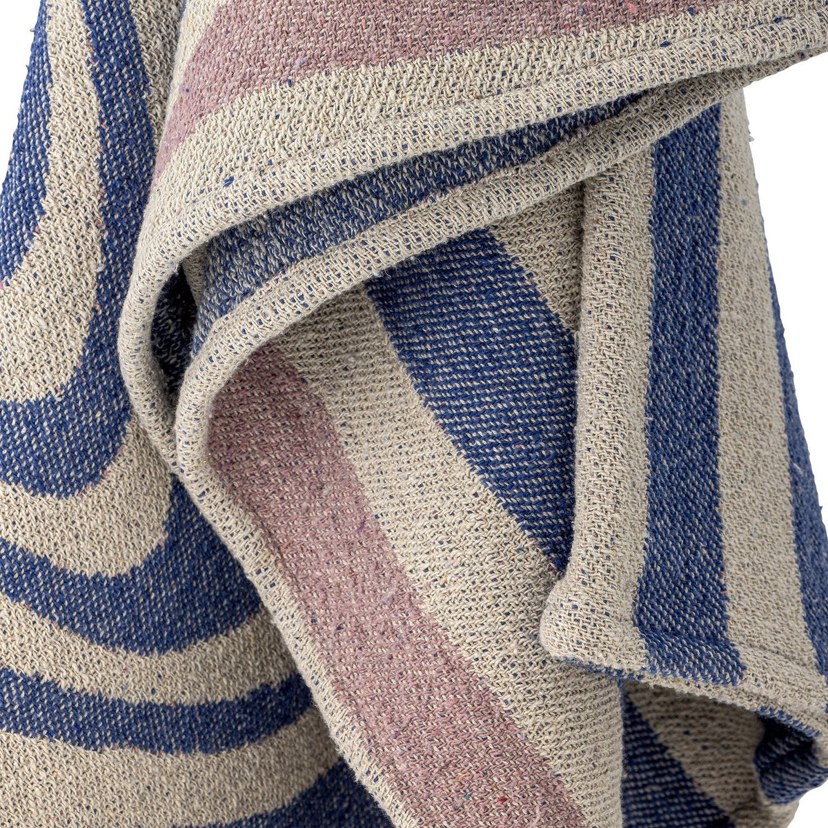 Arlie Throw in blue, a woven fabric throw with swirling bands and straight stripes, shown draped in close-up detail showing the textured weave.
