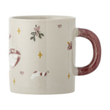 Cream stoneware Christmas mug with maroon handle, embossed with a goose in a "Merry Christmas" ribbon, mistletoe, stars, hearts and a stocking, shown on a white background.
