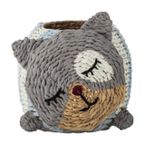 Mille Water Hyacinth Basket shaped like a sleeping bear, with woven grey, white and tan face, embroidered eyes, pointed ears and stubby feet, on a white background.