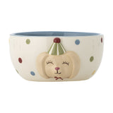 Stoneware kids' bowl in cream with multicoloured polka dots, a blue interior glaze, and a raised dog face wearing a striped party hat on the exterior, shown on a white background.