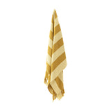 Frello Striped Cotton Throw in yellow, woven with alternating deep and pale yellow stripes, fringed edges, hanging against a plain white background.
