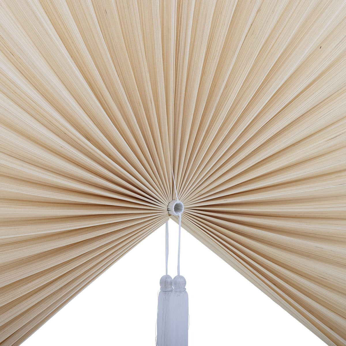Jaime Bamboo Wall Decor 110cm in natural finish, a close-up of pleated bamboo strips fanning from a central ring with a white tassel, shown against a plain white background.