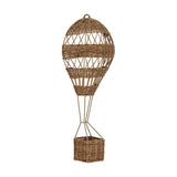 Huggi Rattan Wall Basket in Natural, a hot air balloon-shaped kids' storage piece with a woven rattan balloon on a slim iron frame and a small basket below, shown on a plain white background.