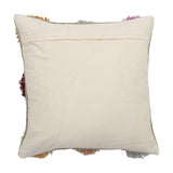 Somma Wool Cushion in Multi, reverse side shown in plain cream fabric with a concealed zip closure, colourful shaggy yarn tufts visible around the edges, on a white background.