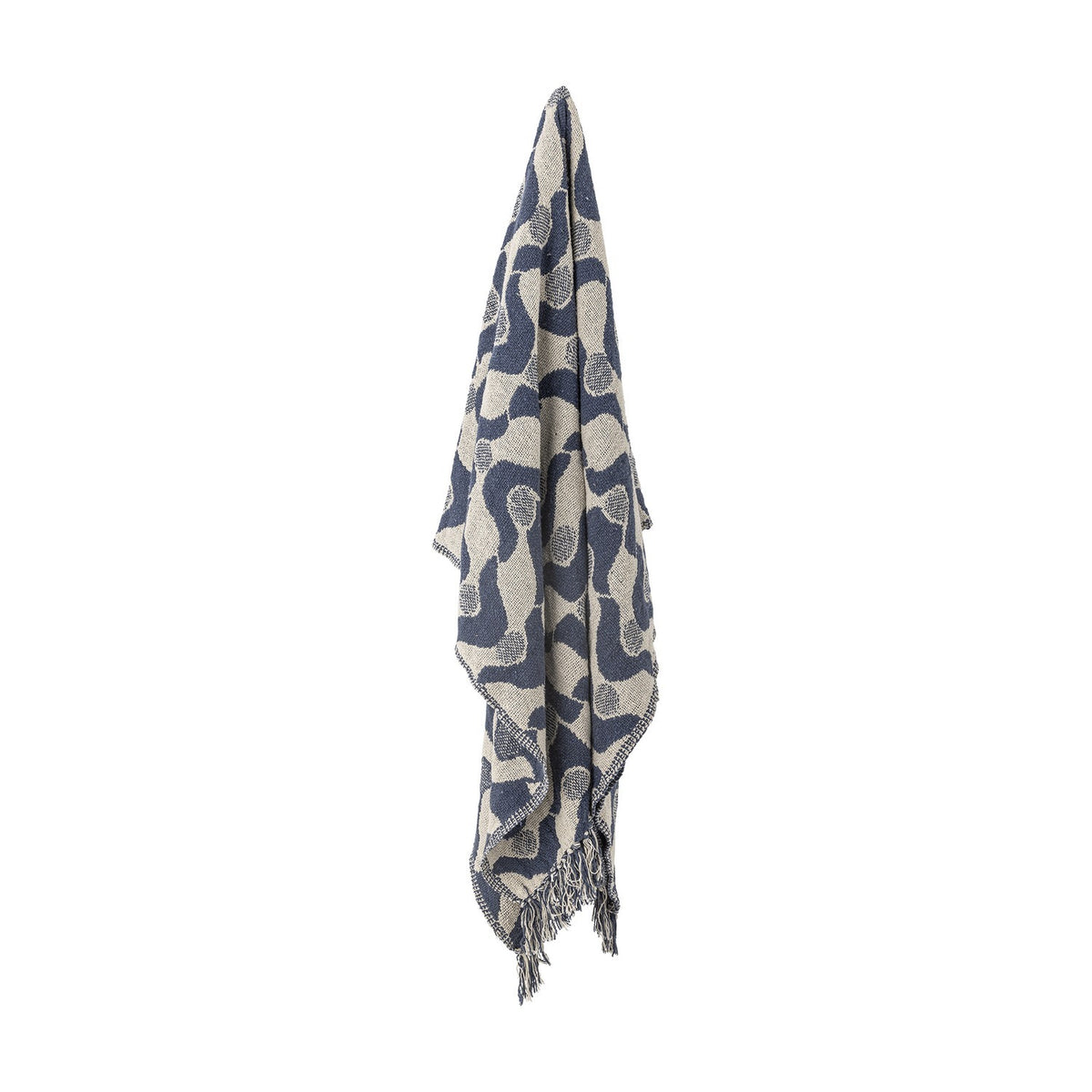 Santena Wavy Cotton Throw in blue, draped with fringed edges, showing a woven wave and dotted circle pattern in navy and beige against a plain white background.