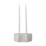 Florida Marble Candle Holder in white, a low curved block holding two tall ribbed taper candles, shown on a plain white background.