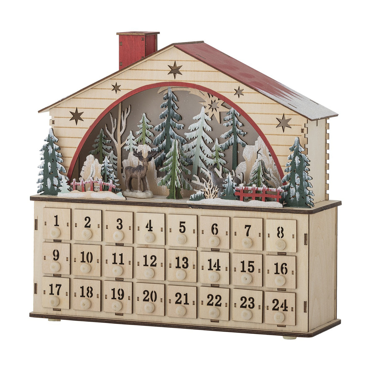 Beige plywood house-shaped advent calendar with red roof, chimney, star cut-outs, an arched woodland scene with deer and fir trees, and 24 numbered drawers, on a white background.