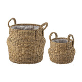 Bjorn Water Hyacinth Baskets, set of 2 in natural woven material, round bodies with narrow necks and braided handles, shown with plastic liners on a plain white background.