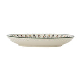 Side view of the Jolly Stoneware Christmas Plate in cream, showing a shallow rim decorated with a row of nutcracker figures, set against a white background.