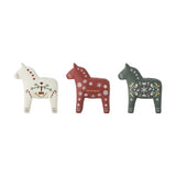 Siffer Horse resin Christmas candle holders, set of 3 folk-style horses in white, red and green with hand-painted hearts, snowflakes and bird motifs, on a plain white background.