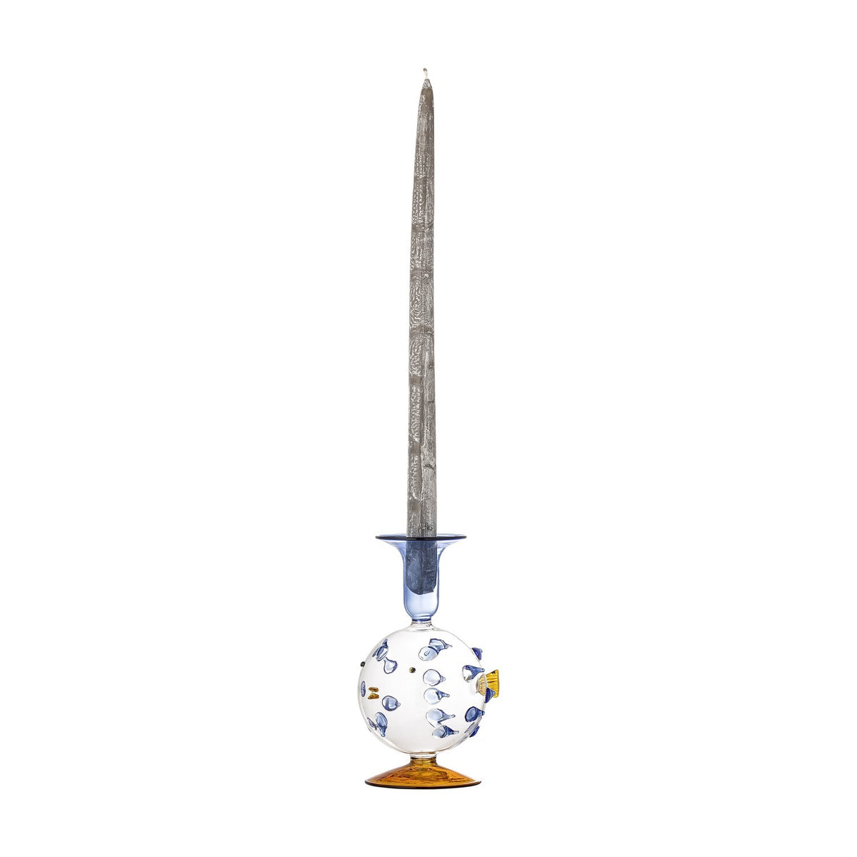 Phila Glass Candle Holder in Blue, a puffer fish-shaped glass holder with blue spine details, a small fin and flared blue cup, amber round base, tall candle inserted, on a plain white background.