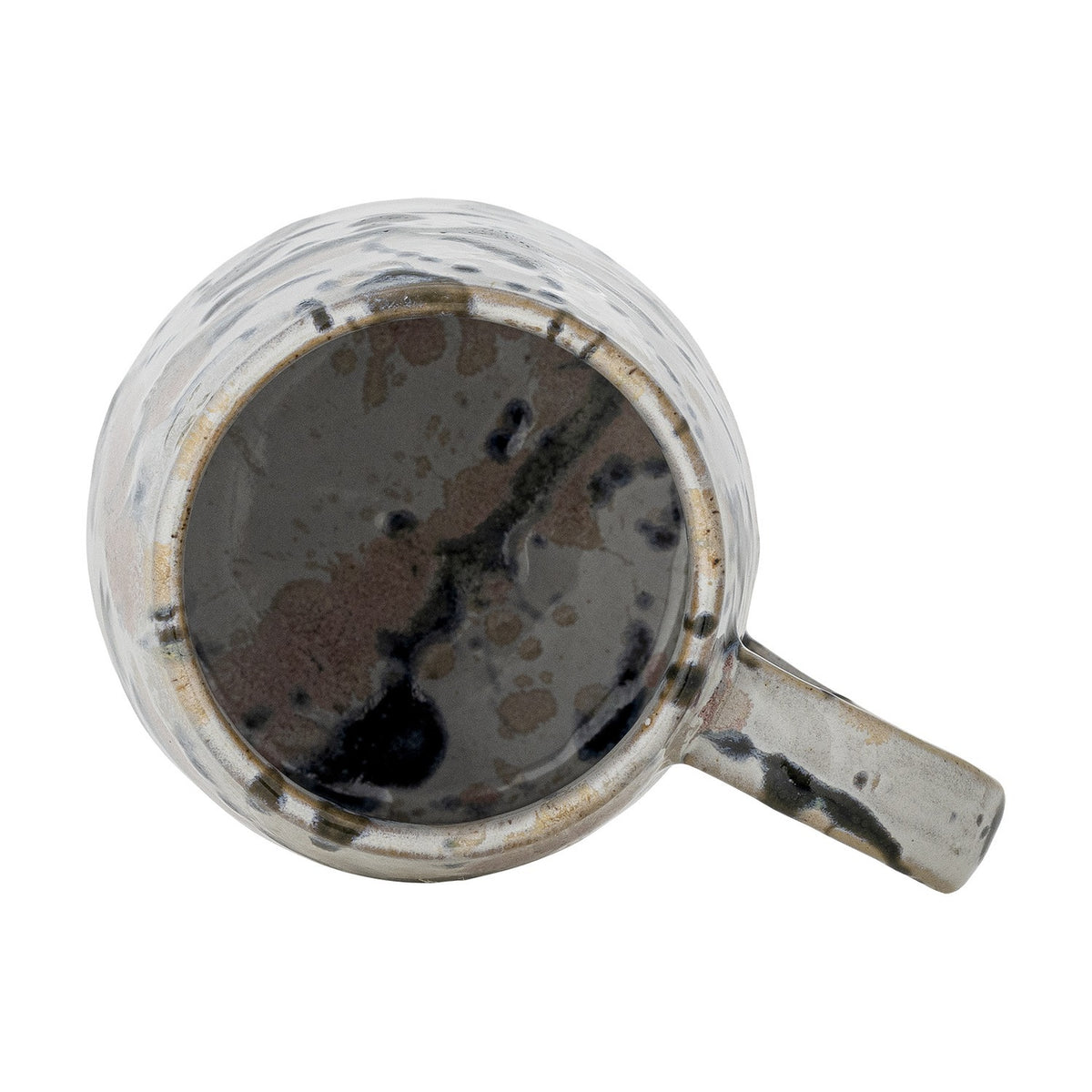 Top-down view of a Winnie stoneware mug with handle, showing its multicoloured reactive glaze splashes and speckles inside and around the rim, on a plain white background.