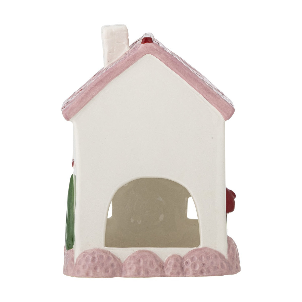 Shirly House stoneware Christmas tealight holder in white, shaped like a cottage with a pink pitched roof, chimney, cut-out arched window, on a plain white background.