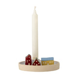 Coze Round Stoneware Candle Holder featuring a shallow ceramic base with red, yellow, and blue miniature houses beside a tall white taper candle, on a white background.