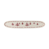 Wonderland Stoneware Christmas Platter in cream, a long narrow oval tray with rounded ends, decorated with a row of pine trees and a branch-patterned border, shown on a plain white background.