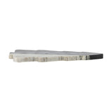 Diya Christmas Tree Marble Chopping Board in black, shown edge-on to reveal its stepped tiered profile and natural veining, set against a plain white background.