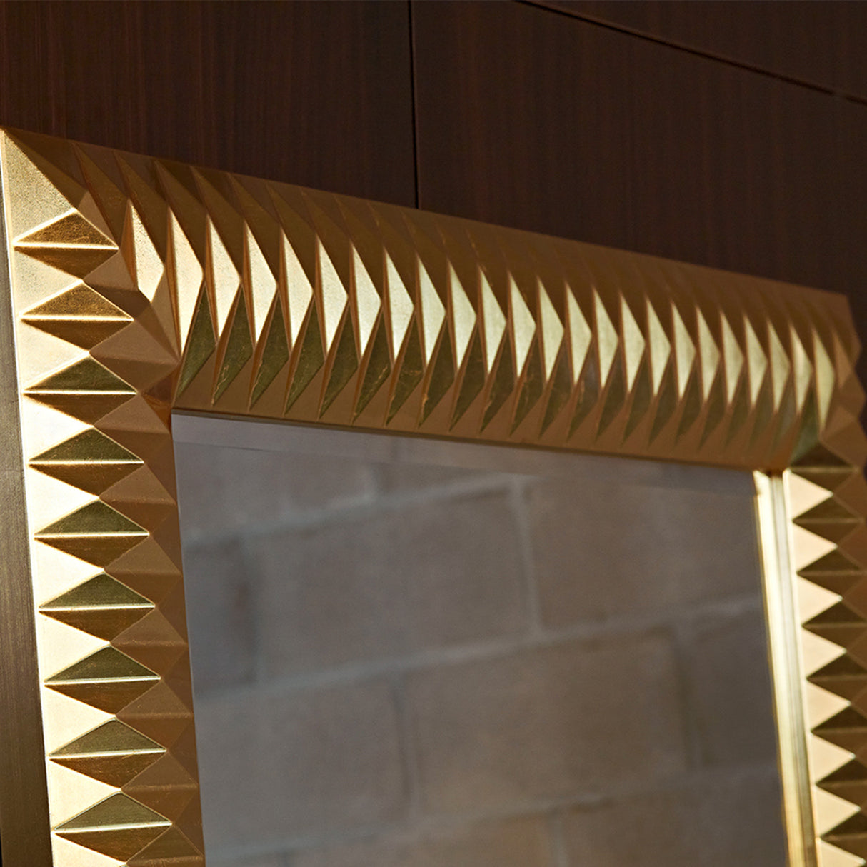 Close-up of the gold leaf pyramids at the frame corner, the rows of facets throwing light in different directions.