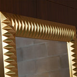 Close-up of the gold leaf pyramids at the frame corner, the rows of facets throwing light in different directions.