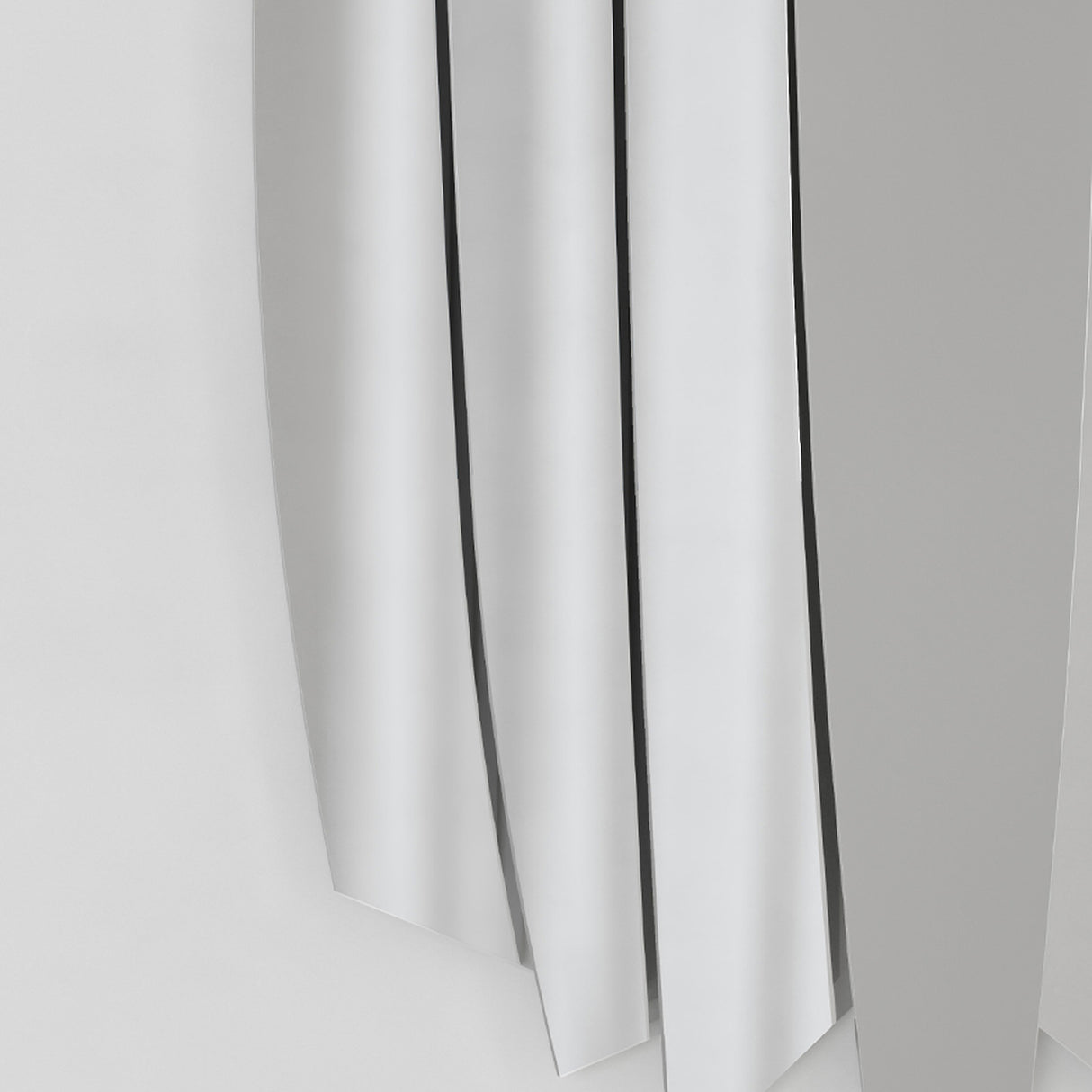 Close-up of the blade edges and the gaps between them, each blade taking the light on its own plane.