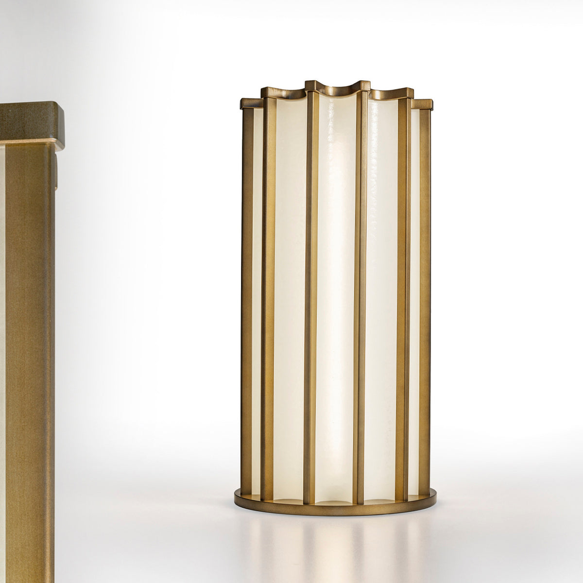 Roma Glass LED Table Lamp in Brushed Bronze, a tall cylindrical fixture with vertical bars framing white glass panels and a scalloped top, shown on a plain white background.