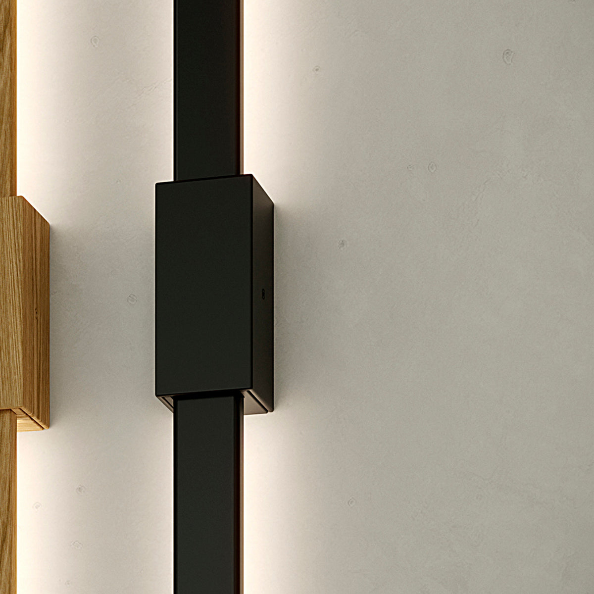 Bow Wall 300 lighting accessory in matt black, slim linear profile with integrated fixing box, shown wall-mounted with soft edge lighting against a pale grey wall.