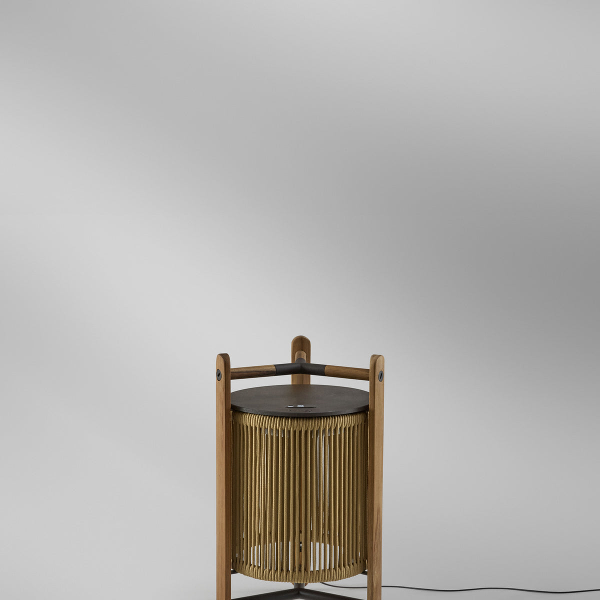 Kando M/40 Wood LED Table Lamp in Sand, a lantern-style design with sand-coloured cord shade inside a teak frame and dark brown top disc, shown on a plain light background.