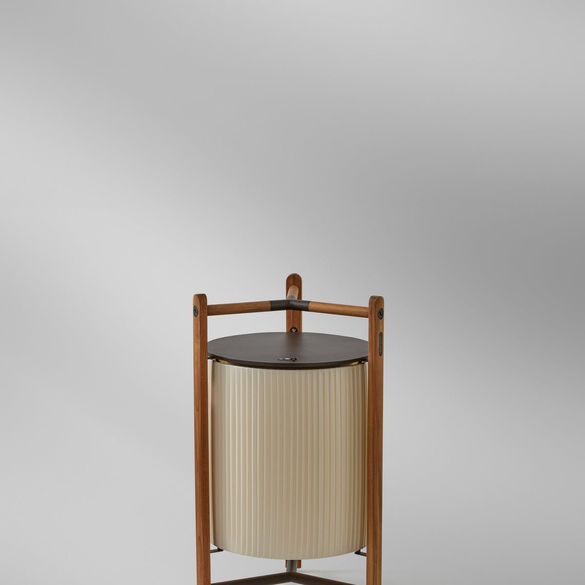 Kando P/76/R rechargeable LED floor lamp with a pleated cream ribbon shade inside a three-legged wood frame and dark round top, shown on a plain light background.