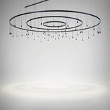 Skybell Circle Iron Ring LED Pendant Light in Ebony Black, with three concentric rings and multiple cone-shaped heads on slim hanging stems, shown against a plain light grey background.