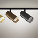 Street 3 LED track spotlights with cylindrical heads on short stems, shown in brushed brass, bronze and black finishes mounted on a black track.