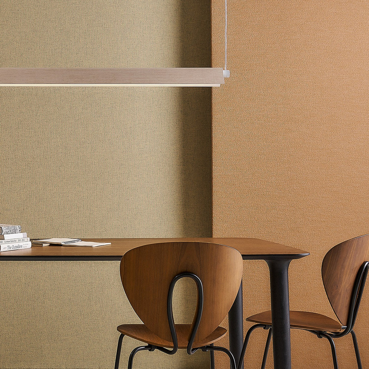 Roof S130 Casing in wood-toned finish shown as a slim linear pendant light above a dining table with wooden chairs, set against green and terracotta walls.