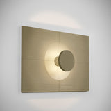 Arid Wall Light Tile in Textured Olive Grey, a fluted aluminium wall panel with a circular cut-out illuminated by a warm integrated light, shown on a plain light background.
