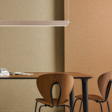 Roof S160 Glass LED Pendant Light in light wood finish, a slim linear fixture suspended above a wooden dining table with chairs, set against beige and terracotta walls.