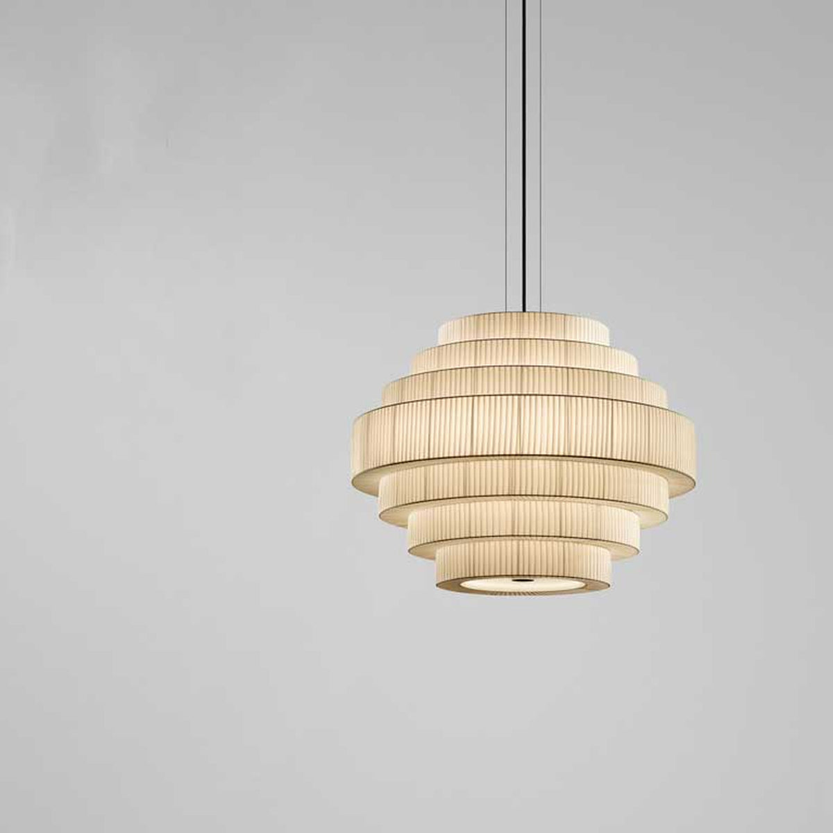 Mos 02 Ribbon Tiered Pendant Light with seven pleated cream translucent ribbon tiers stepping from narrow top to wide middle and base, iron structure, shown against a plain grey background.