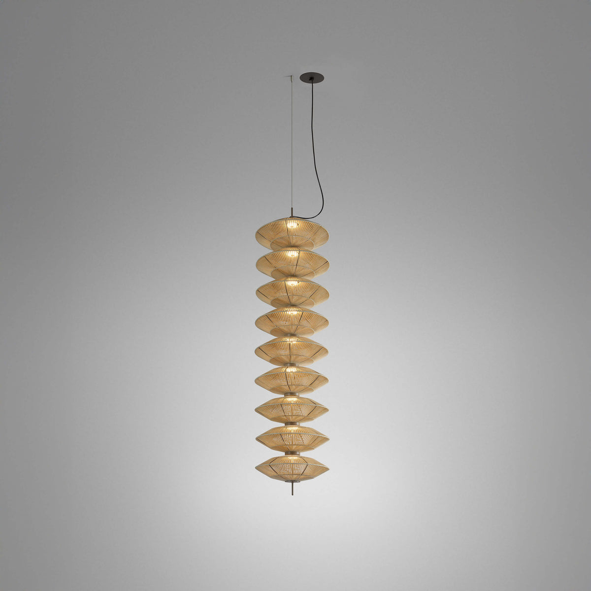 Yuyun S/9L pendant light with nine stacked woven cotton thread shades in satin beige, aluminium and steel frame, integrated LED, shown on a plain grey background.