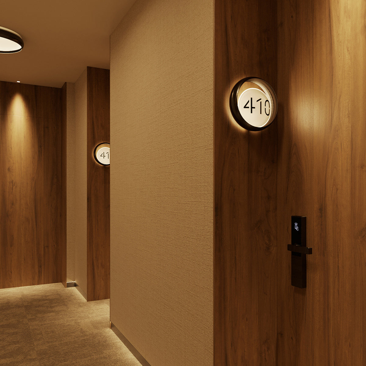 Ring W1 Number Glass Ring wall light in dark wood finish, round fitting with illuminated white disc showing room number "410," mounted on wood-panelled hotel corridor wall.