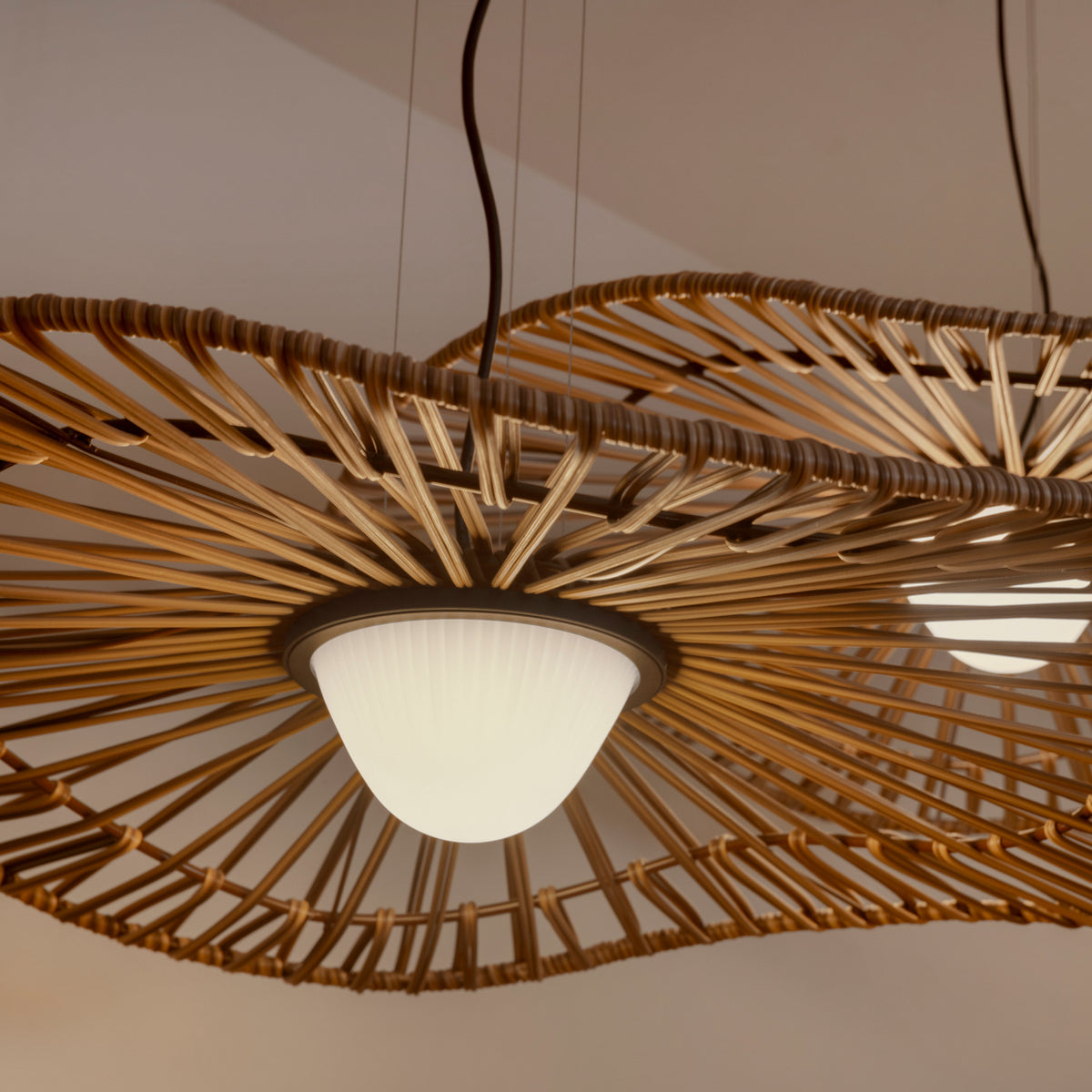Mediterrània S/105 outdoor pendant light with wide disc-shaped shade of radiating brown slats around a white ribbed LED diffuser, close-up view against a neutral ceiling.
