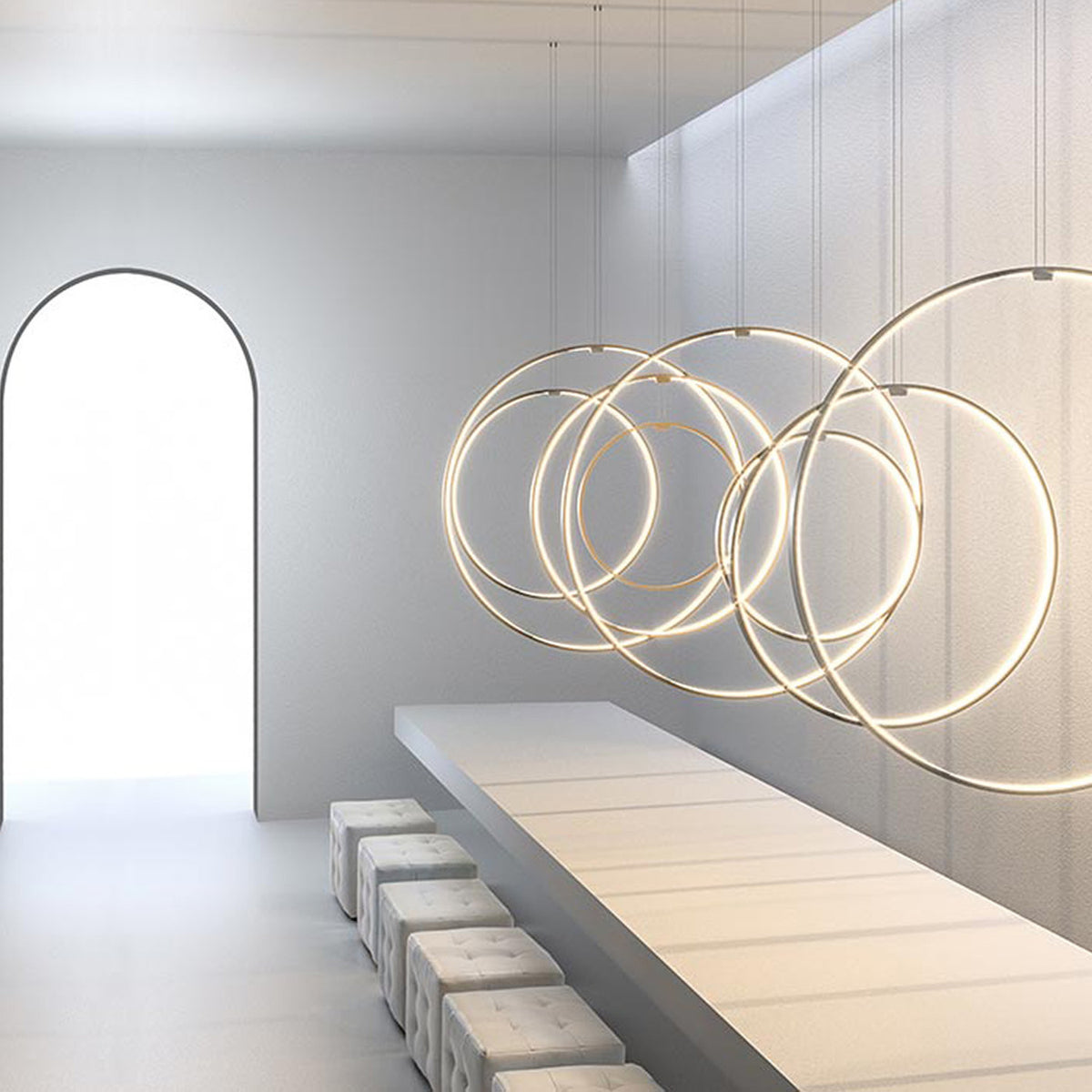 Zero Round Vertical Ring Pendant Light, 50cm circular LED design in brushed brass, shown in multiples above a white dining table in a bright room with an arched doorway.