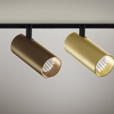 Street 5 Aluminium LED track spotlights in bronze and brushed brass finishes, cylindrical heads with honeycomb louvre lenses on a black track, shown against a plain background.