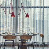 Blux C Aluminium Dome Ceiling Light in red, shown in a dining setting with zig-zag arms and dome shades above a table with wooden chairs and sheer curtains.