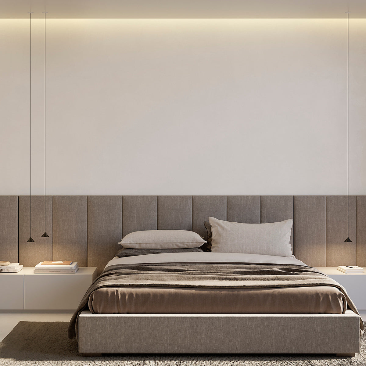 Three slim matt black cone pendant lights, including the Rendez-vous, hang on fine cables above a bed with grey upholstered headboard in a bedroom setting.