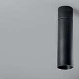 Lola Cylinder LED Ceiling Light in matte black, a slim single-tube downlight mounted flush to the ceiling against a plain light grey background.