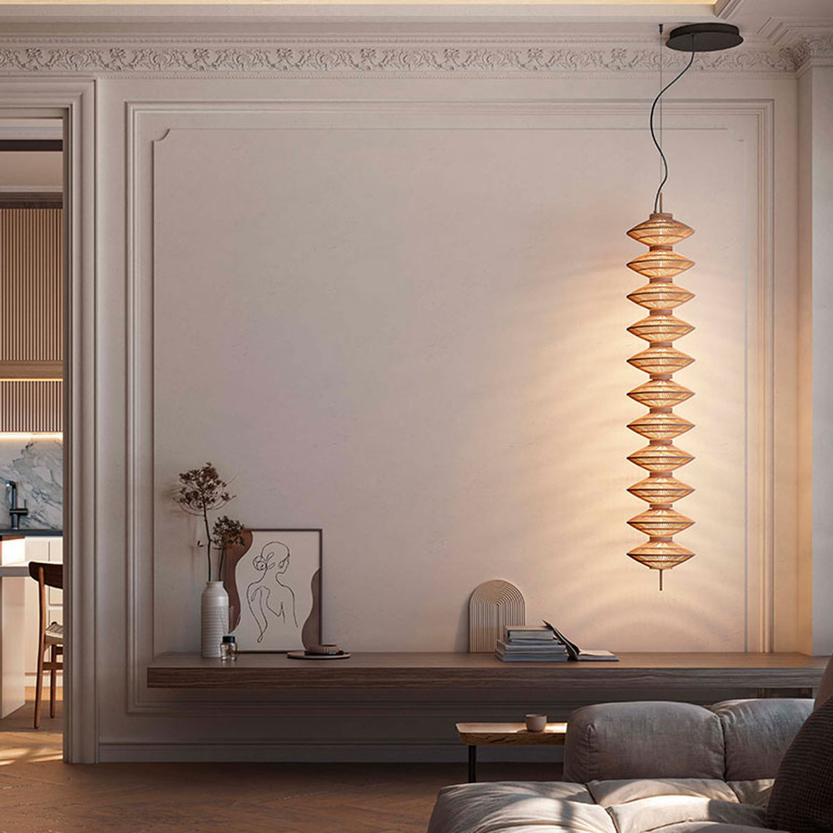 Yuyun S/11L/I pendant light with eleven stacked beige thread tiers on a slim stem, shown illuminated beside a wall-mounted console in a living room.